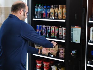 A man refills a Smart Store at an office