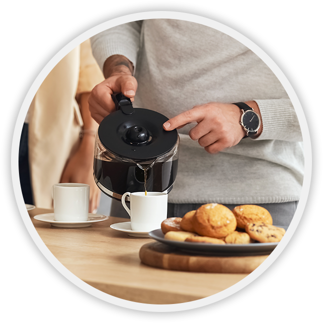 man pouring coffee into cup