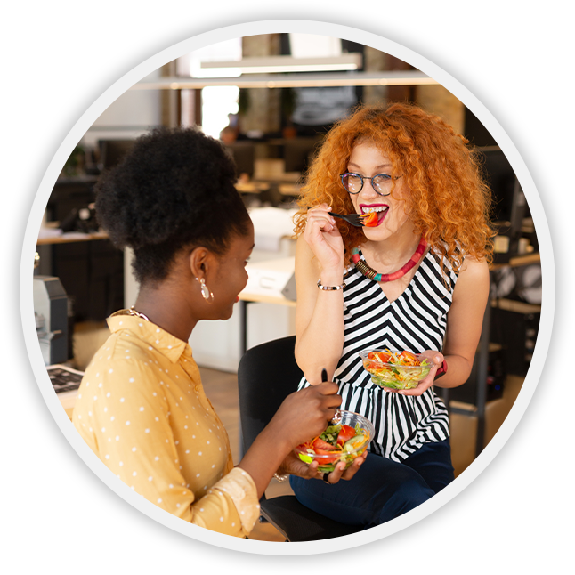 two women eating healthy snacks